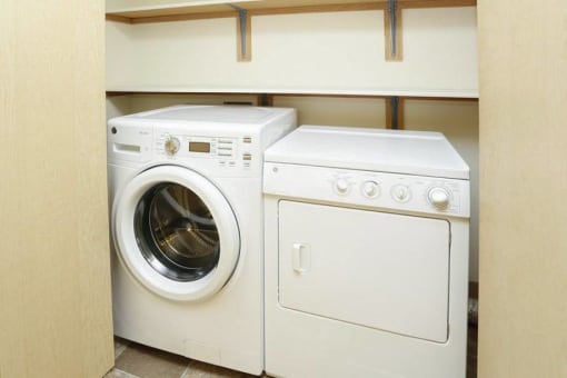 a washing machine and a dryer in a closet at Troutdale Terrace, Oregon 97060
