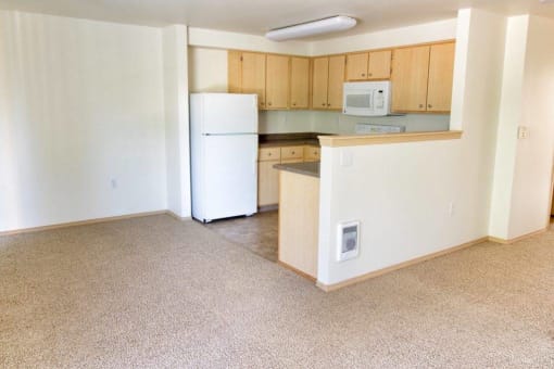 an empty kitchen with a microwave and a refrigerator at Troutdale Terrace, Troutdale,  97060