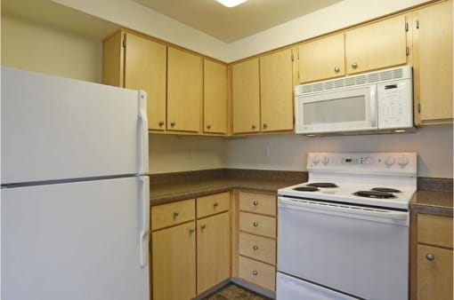 a kitchen with a stove microwave and refrigerator at Troutdale Terrace, Troutdale, Oregon