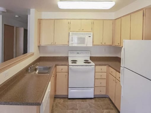 a kitchen with washer at Troutdale Terrace, Troutdale, Oregon