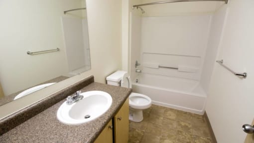 a bathroom with a sink toilet and a bath tub at Troutdale Terrace, Troutdale, OR