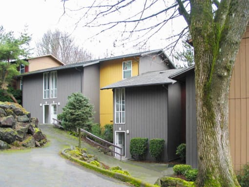 the exterior of a house with a driveway and a tree at Whisperwood, Washington 98168