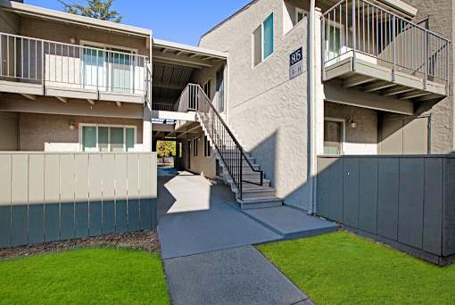 A concrete building with a staircase leading to the entrance at The Henley Apartments, Suisun City, 94585
