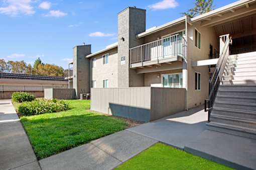 A modern house with a balcony and stairs leading to the second floor at The Henley Apartments, Suisun City, California
