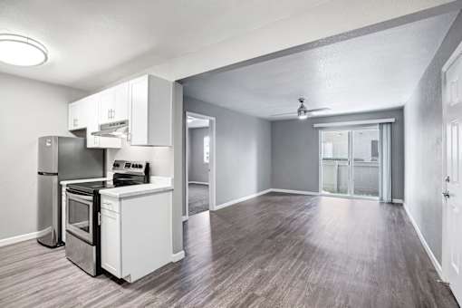 A kitchen with a refrigerator, oven, and sink at The Henley Apartments, Suisun City, CA