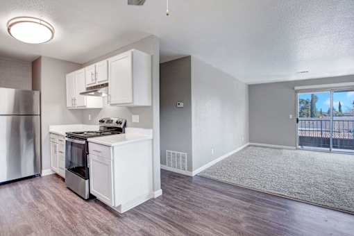 A kitchen with white appliances and cabinets at The Henley Apartments, California, 94585