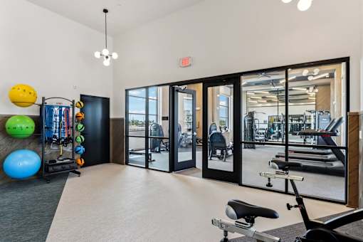 A gym with a variety of equipment including a stationary bike at Ironwood Ranch Apartments,Arizona,85138