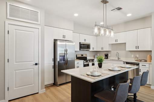A modern kitchen with a center island and stainless steel appliances at Ironwood Ranch Apartments,Arizona,85138
