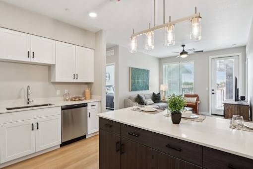 A modern kitchen with a large island and a dining area at Ironwood Ranch Apartments,Maricopa