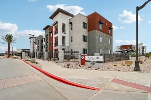 A street view of a residential area with a sign that reads Ironwood Ranch Apartment homes  at Ironwood Ranch Apartments,Maricopa,AZ