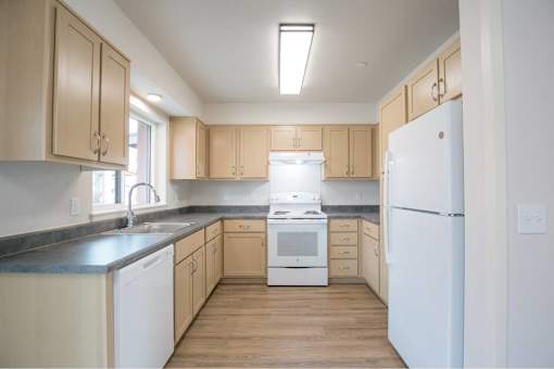 Kitchen with white appliances at Bridge Meadows Redmond Apartments, Oregon