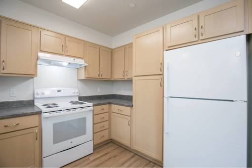 Kitchen with white refrigerator at Bridge Meadows Redmond Apartments, Redmond, Oregon