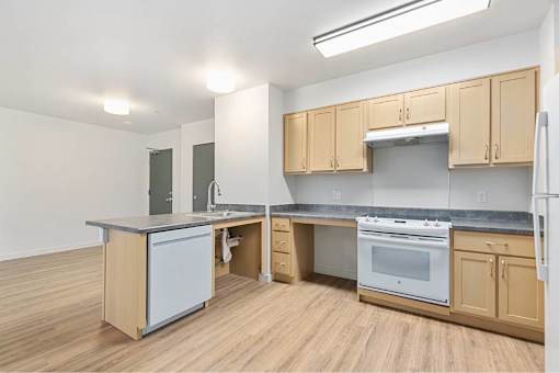 Kitchen with wooden cabinets at Bridge Meadows Redmond Apartments, Redmond, OR, 97756