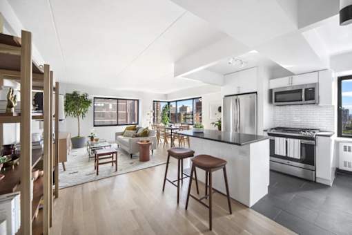 A modern kitchen with a bar stool and a countertop.