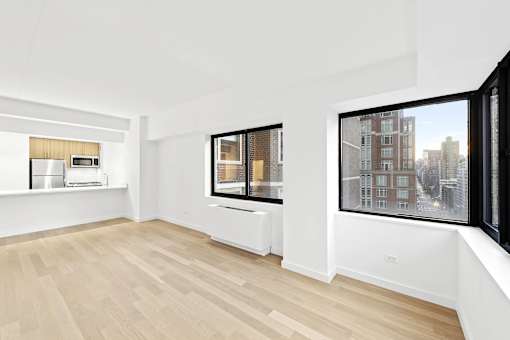 A room with a window overlooking a cityscape.