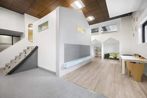 A white room with a staircase and a table.