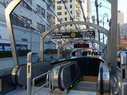 A subway station entrance with a sign that reads "Elevator at 96 Street Subway Station".