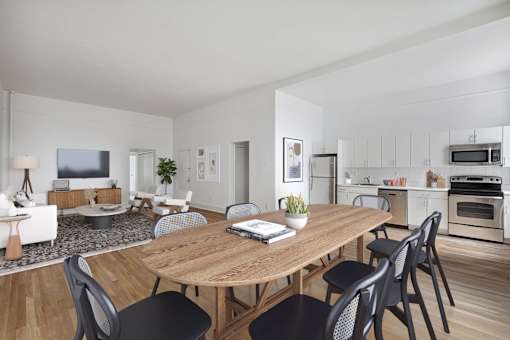 A modern dining room with a wooden table and chairs.