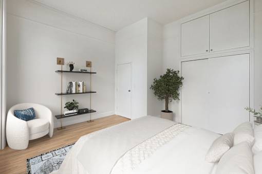 A white bedroom with a bed, chair, and shelves.