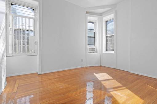 A room with wooden floors and white walls.