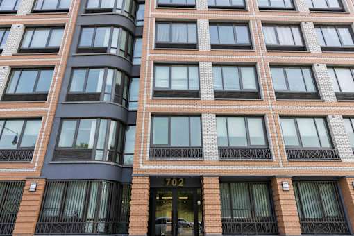 A tall building with the number 702 on the door.