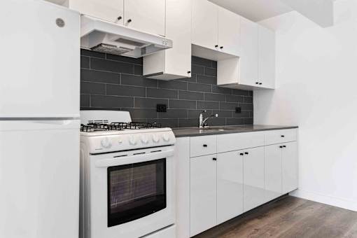 A modern kitchen with a white stove and cabinets.