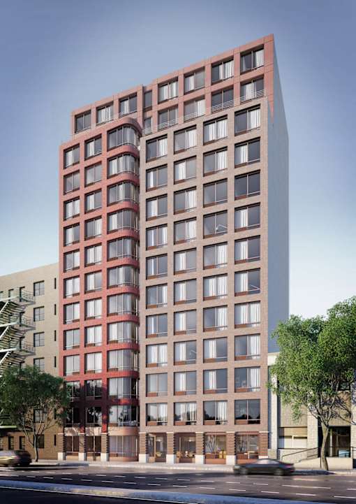 A red and brown building with many windows is shown.
