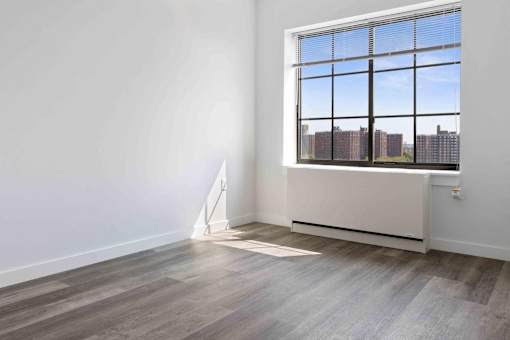 A room with a large window overlooking a cityscape.