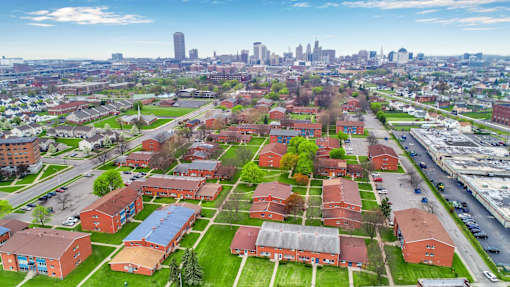 A view of a city from a high vantage point with buildings and a road.