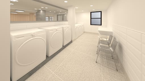 A laundromat with washers and dryers lined up.