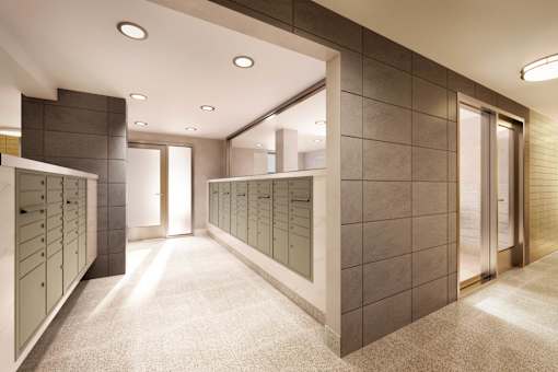 A hallway with a carpeted floor and a wall of mirrors.
