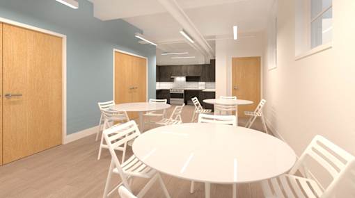 A white table surrounded by white chairs in a room with blue walls.