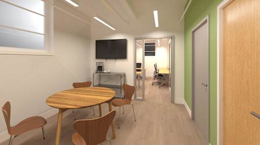 A conference room with a table and chairs.