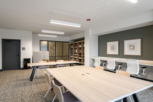 a meeting room with tables and chairs