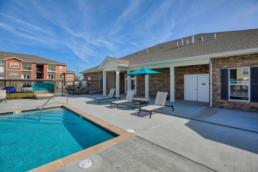 Pool with patio furniture at Salish Flats APARTMENTS, Airway Heights, WA