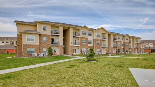 Exterior community buildings with grass at Salish Flats APARTMENTS, Airway Heights, WA