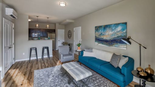 Wood-Style Flooring with Comfortable Couch and Blue Wall Art at Salish Flats APARTMENTS, Airway Heights, WA