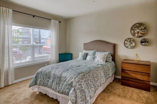 Bedroom with High Ceilings, Carpet Flooring, and a Large Window at Salish Flats APARTMENTS, Airway Heights, WA