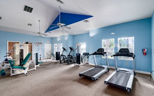 A gym with treadmills, weights, and exercise equipment.at Valencia Trace, ORLANDO Florida