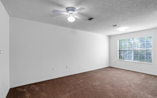 A room with a ceiling fan and carpeted floor.at Valencia Trace, ORLANDO, FL