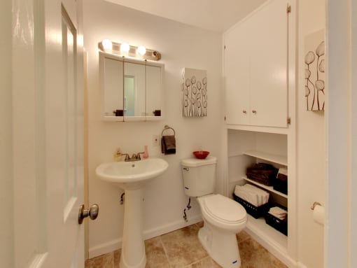 The Post Apartments bathroom with vanity and storage