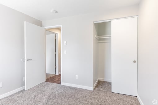 a bedroom with white walls and carpet at Township Eastside, Portland, 97236