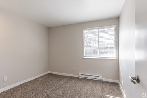 a bedroom with a window and carpet at Township Eastside, Portland, 97236