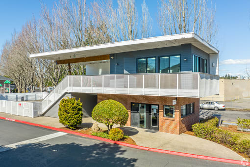 a blue house with a balcony and a parking lot in front of it at Township Eastside, Oregon