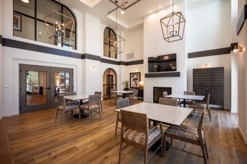 a dining room with tables and chairs and a fireplace at Vintage at Anacapa Canyon, Camarillo, California