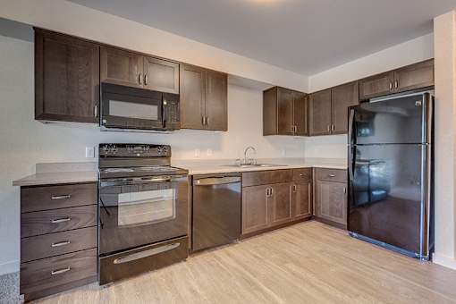 Kitchen with cabinets at VINTAGE AT MILL CREEK, Mill Creek, WA