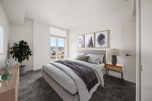 a bedroom with a bed and a window at Grand and Linden Family Apartments, South San Francisco, California