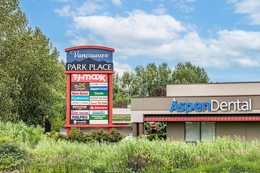 A sign for Vancouver Park Place with a T-Mobile store and an Aspen Dental office.at Vancouver Mall Apartments, Vancouver, WA ? 