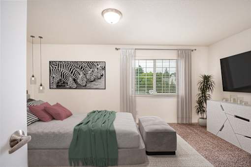 A bedroom with a bed, a couch, and a television.at Vancouver Mall Apartments, Vancouver, 98662 ? 