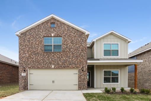 a brick house with a white garage door